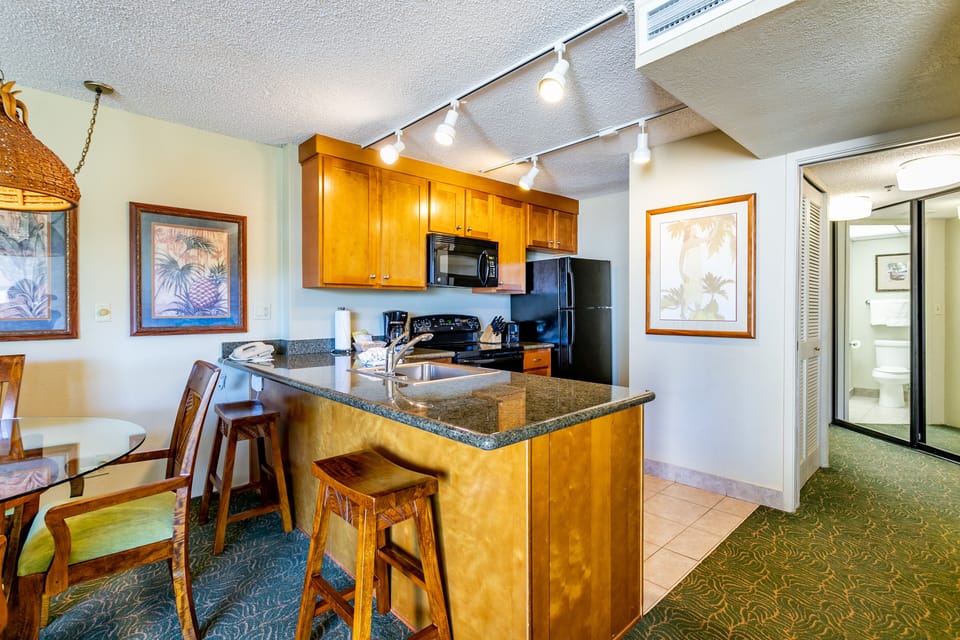 Picture yourself preparing island-inspired meals in your well-appointed kitchen, complete with granite counters, full appliances, and a convenient breakfast bar where you can sip morning coffee.