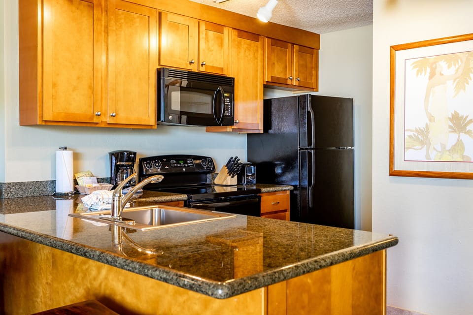 Your home away from home features a fully-equipped kitchen with granite countertops, modern appliances, and everything you need to prepare delicious meals during your stay.