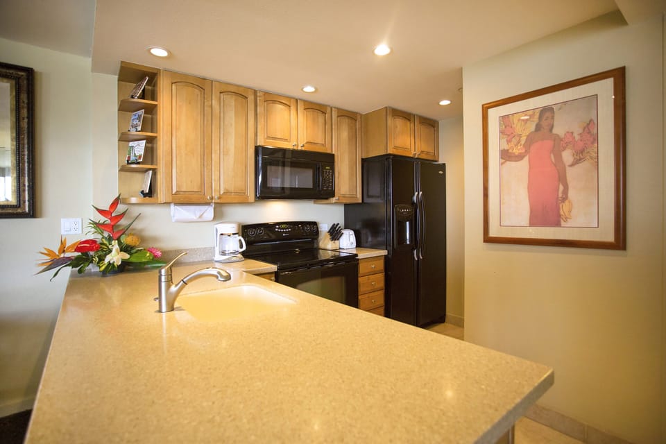 Step into your fully equipped kitchen with warm wood cabinetry, modern appliances, and ample counter space for preparing meals during your stay.