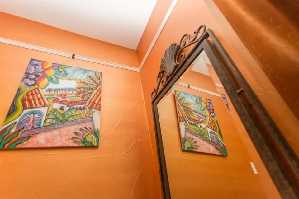 Full length mirror in the bedroom, local art.