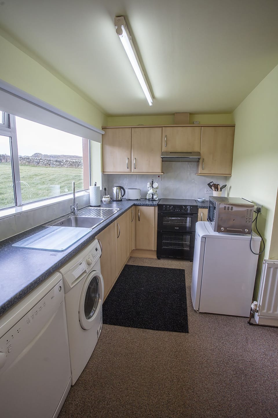 full modern kitchen with dishwasher and washing machine