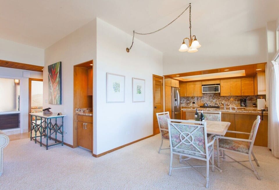 Dining table off kitchen features ocean views dreams are made of