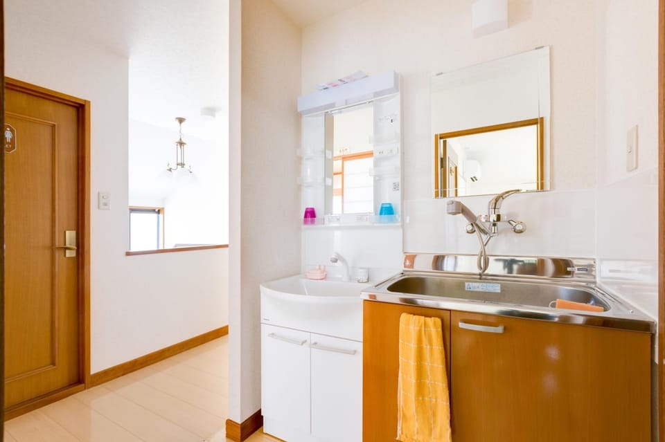 Shower, rainfall showerhead, slippers, towels