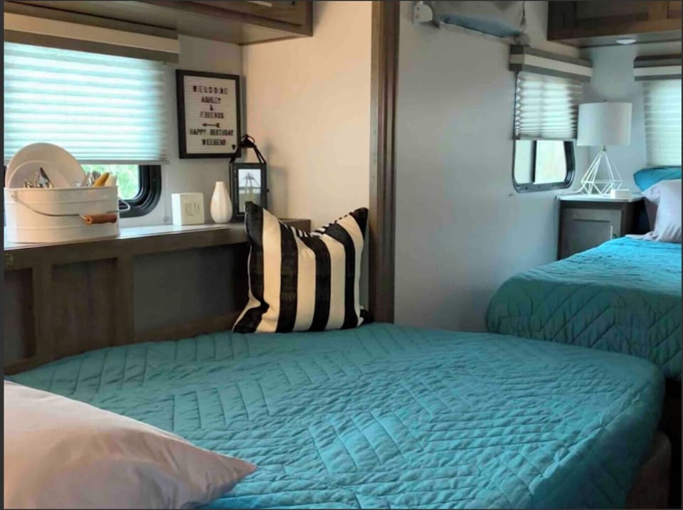 Space with the 2nd bed made. 2nd bed is made with dinette couch and table. 

