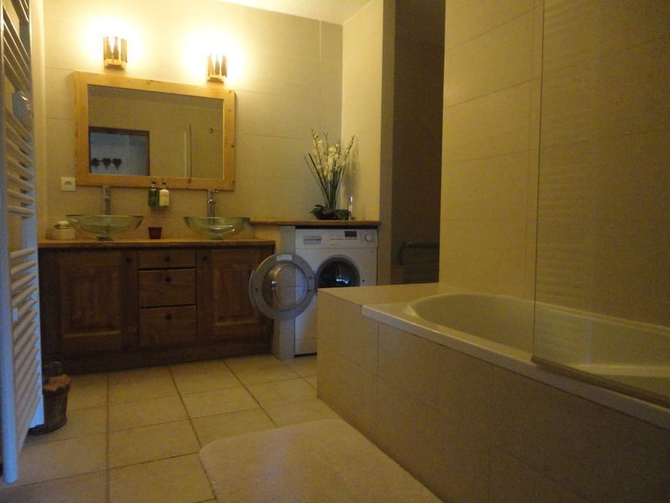 Bathroom and toilet. ~Bath with power shower over , washer dryer machine