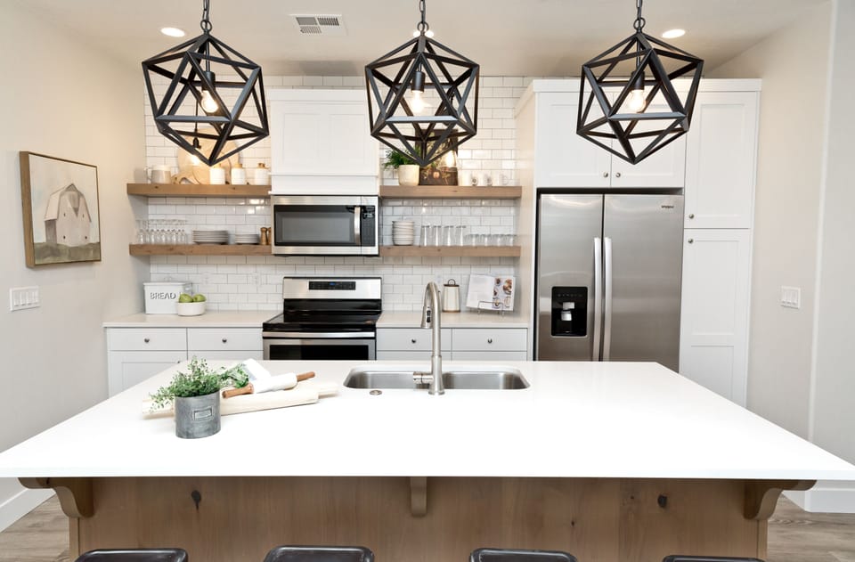 Kitchen island with custom light fixtures and open shelving.