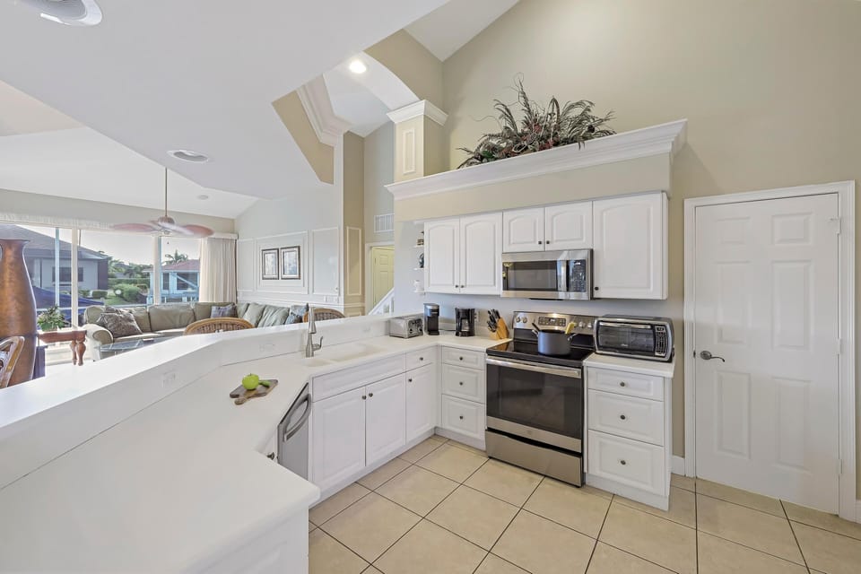 House, Multiple Beds (Large waterfront home with all-day su) | Private kitchen | Fridge, microwave, oven, stovetop