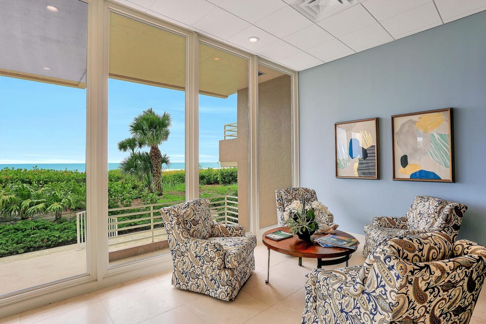 Condo, Multiple Beds (Beachfront condo with 180-degree view) | Living room | Flat-screen TV