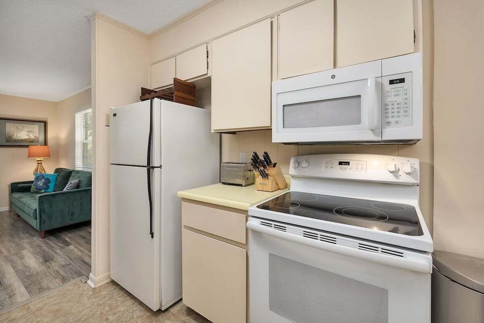Kitchen with white appliances and beige cabinets