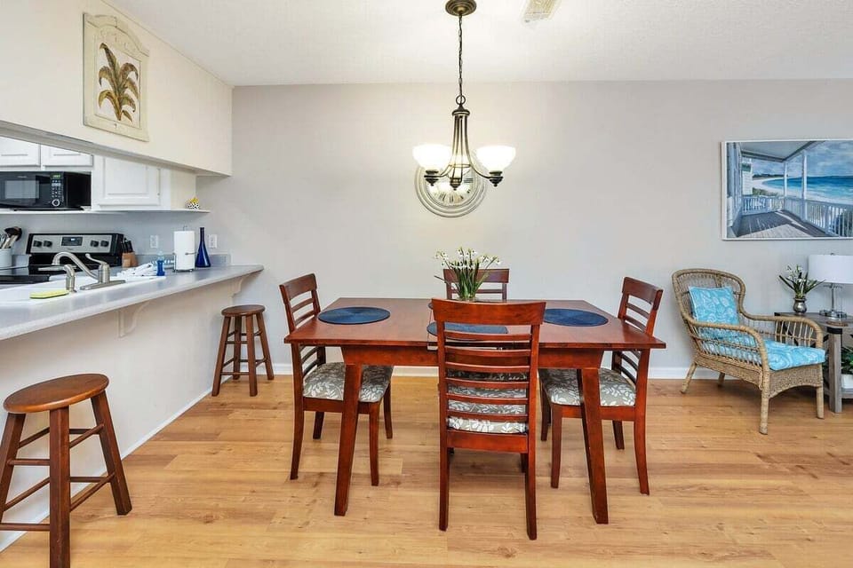 Dining area with wood table and kitchen view