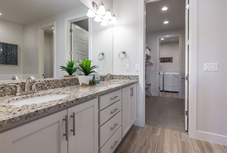 Main Bathroom - With access to the walk-in closet and laundry room this large and spacious bathroom also includes a walk-in shower, bath tub, his and her sinks, toilet and large vanity.