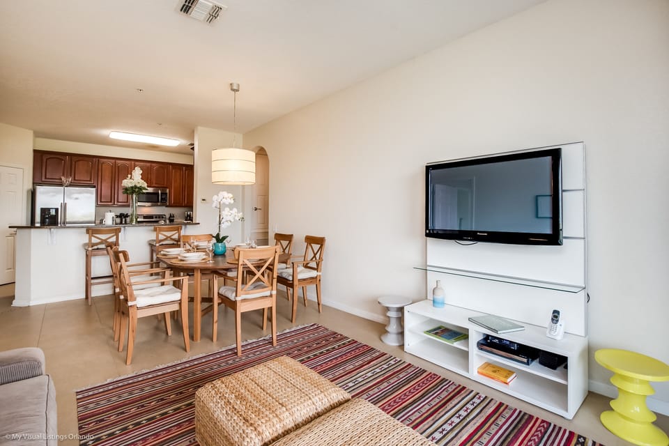Cosmopolitan Comfort: Unwind in our living area, featuring a sleek kitchen and a dining space, designed for both stylish entertaining and everyday living