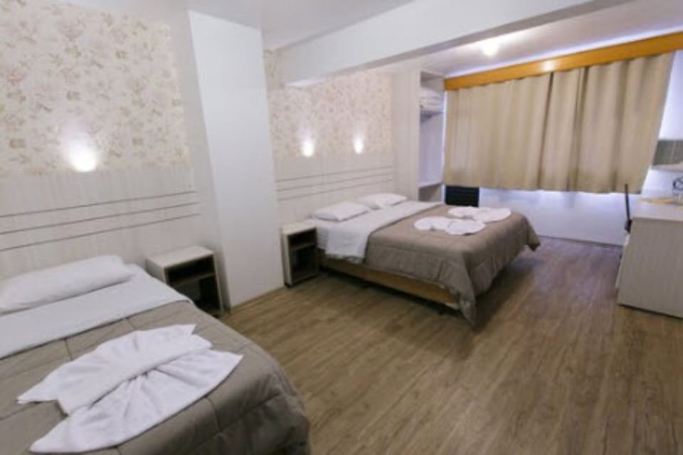 Triple Room | Minibar, desk, blackout drapes, iron/ironing board