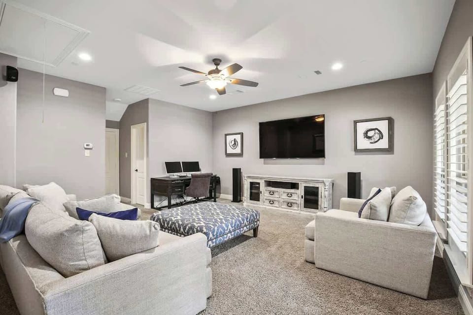 Third floor entertainment/living area with full bathroom and patio