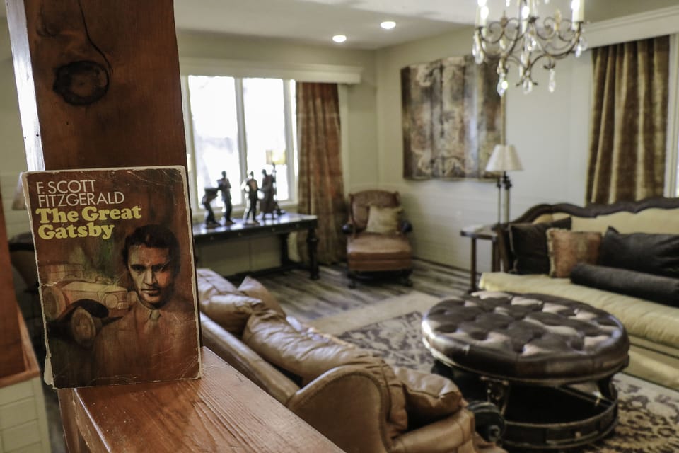 'The Great Gatsby' living room with a stone fireplace and 70" tv.