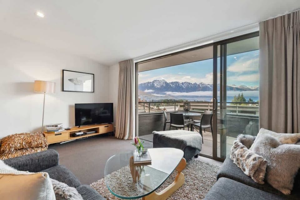 Open plan living with private balcony looking towards the Remarkables over looking Lake Wakatipu 