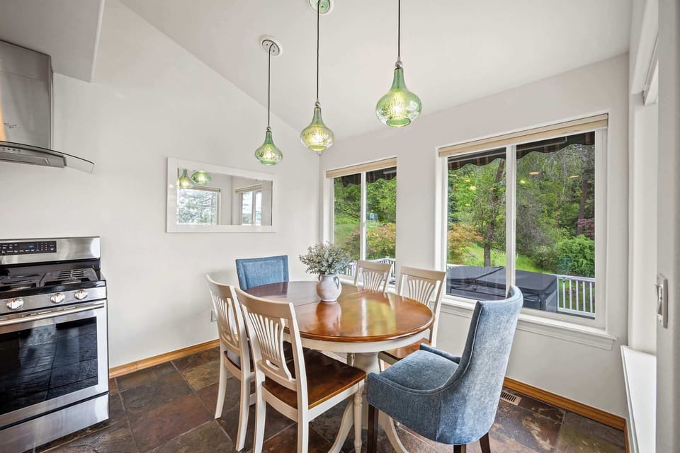 Savor meals around your beautiful wood dining table while gazing at peaceful garden views through expansive windows.