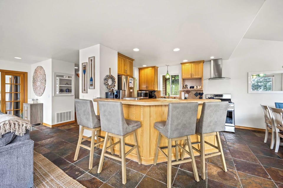 Gather around your spacious kitchen island for morning coffee or evening conversations in this beautifully appointed culinary space.