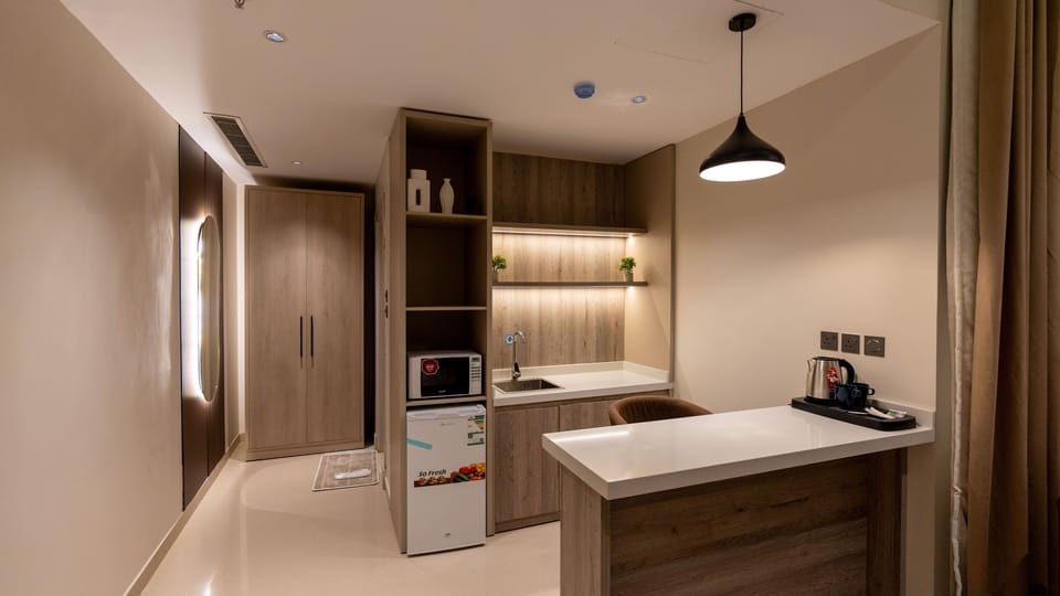 Standard Suite, 1 King Bed | Private kitchen | Fridge, eco-friendly cleaning products, paper towels