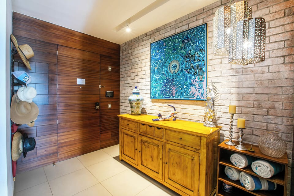 Step inside to find a welcoming entryway that sets the tone for your stay, with warm wood tones, exposed brick, artistic touches, and thoughtful storage for all your vacation essentials.