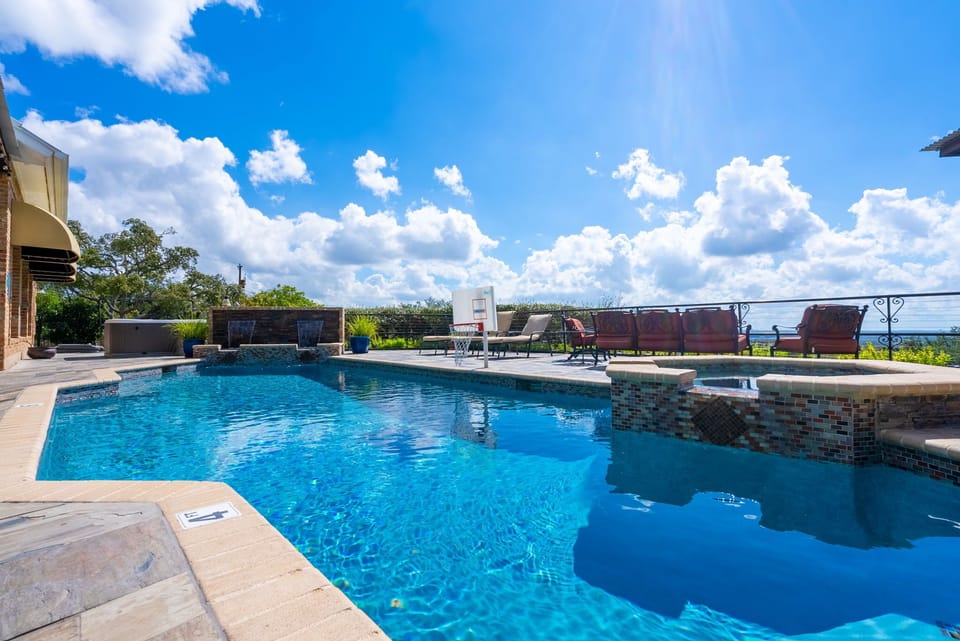 The pool also contains a waterfall and basketball hoop.