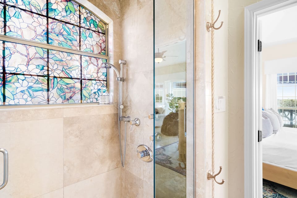 The shower in the ensuite master bath also includes a rainfall showerhead above.