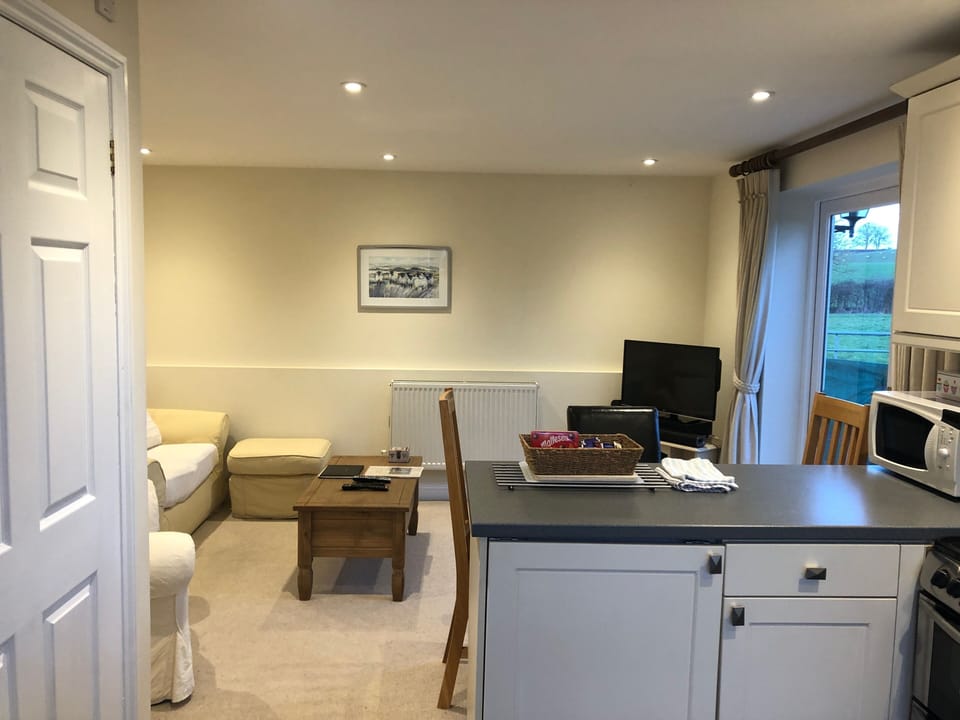 Pear Tree Cottage open plan living room with french doors onto the patio