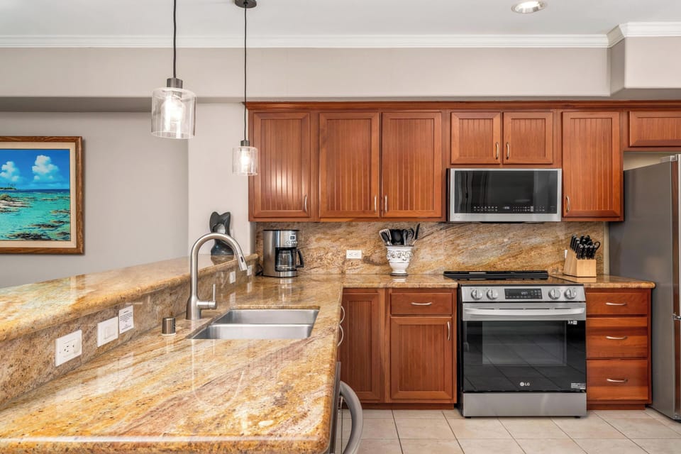 Your fully equipped kitchen features granite countertops, stainless steel appliances, and warm wood cabinetry for effortless meal preparation.