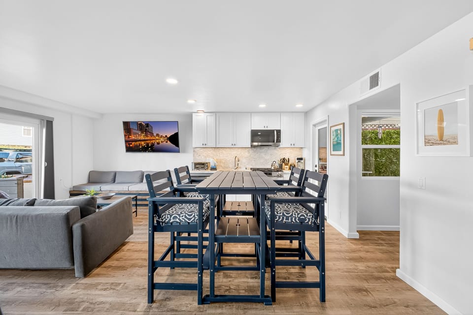 Spacious open-concept living, dining, and kitchen area, perfect for family meals, entertaining, and staying connected while enjoying a beachside vacation.