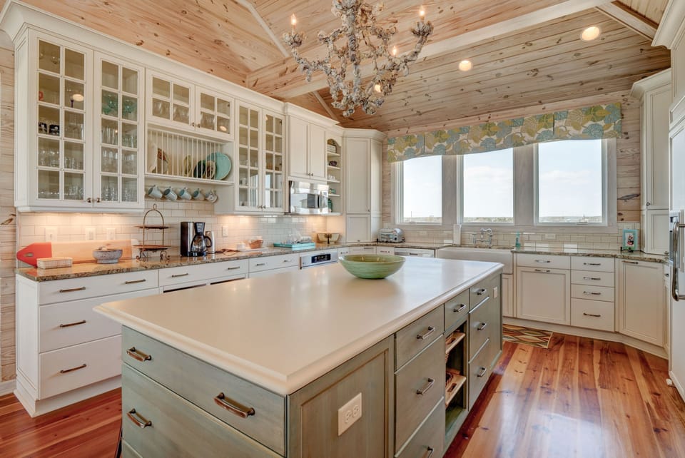 Kitchen with 2 large sinks, 2 dishwashers, 2 large ovens, and microwave
