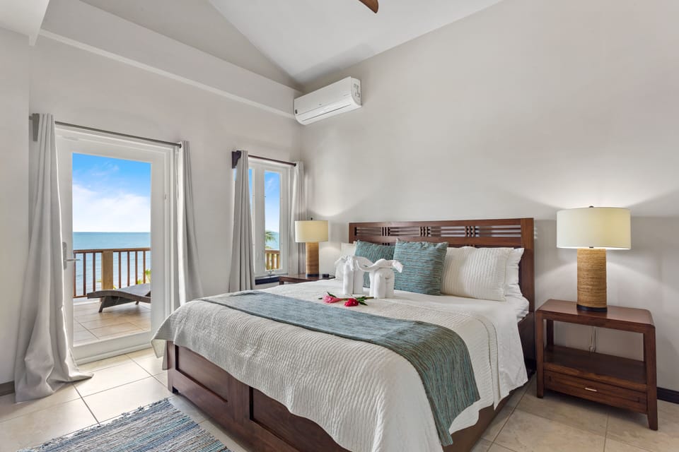 Master bedroom (2nd floor) with king bed, en suite bath, balcony with ocean view