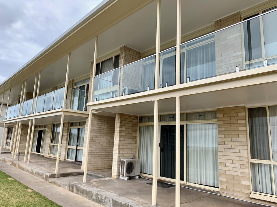 The entire building has been beautifully repainted, enhancing its charm and appeal. Glass balustrades for enhanced ocean vistas