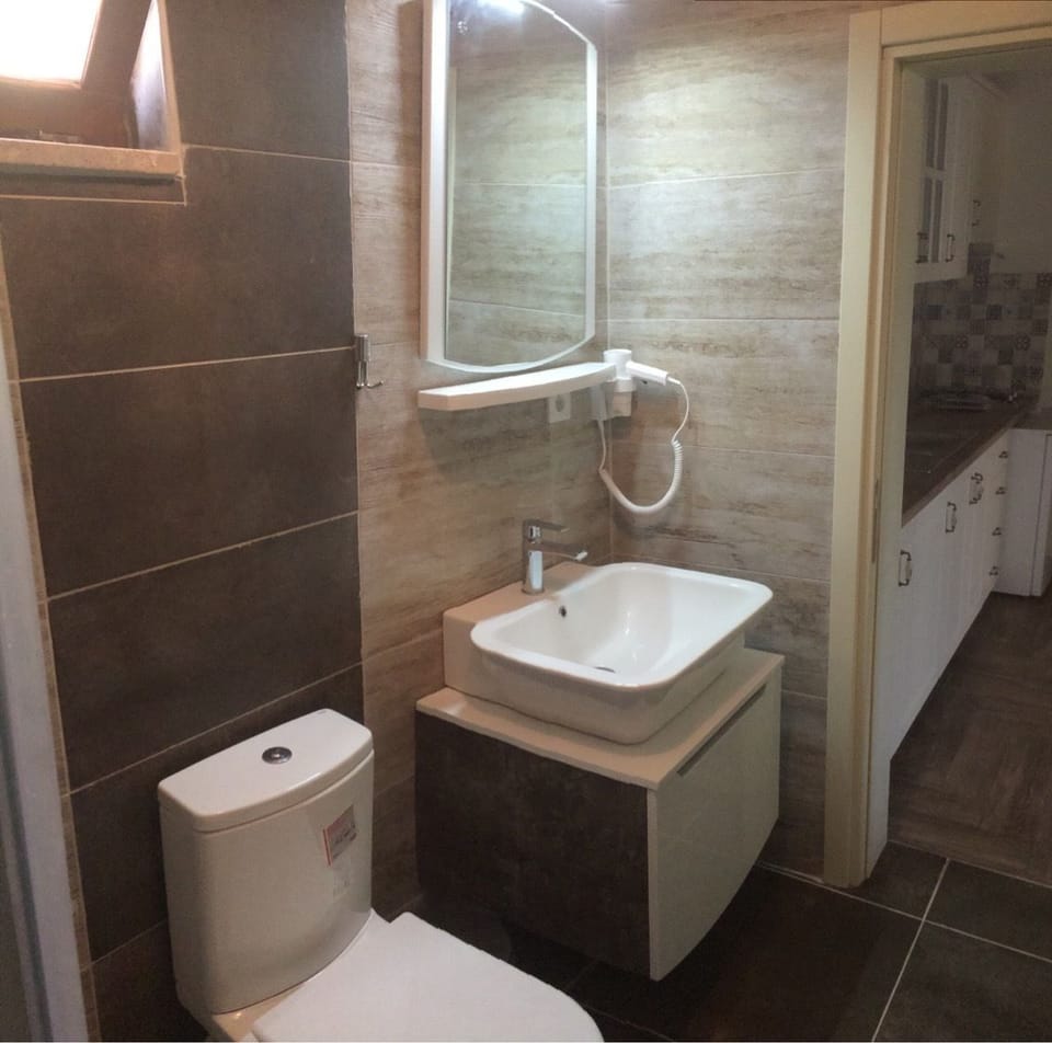 Shower, hair dryer, slippers, towels