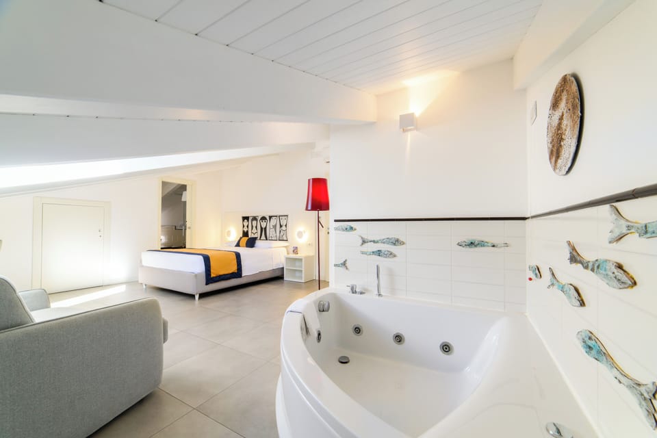Deluxe Suite, Jetted Tub | Minibar, in-room safe, desk, soundproofing