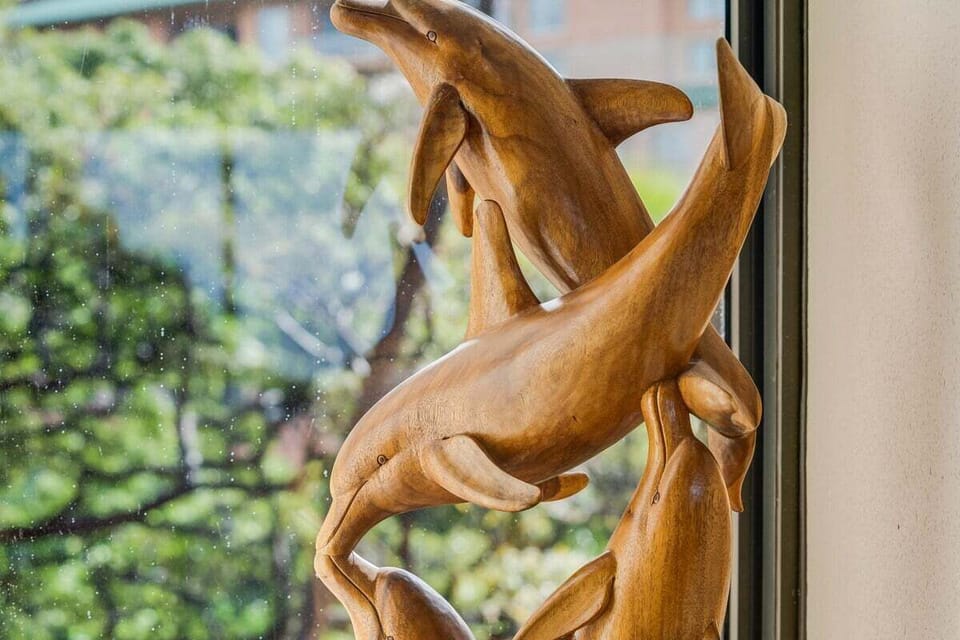 A beautiful wooden dolphin sculpture adds a touch of ocean-inspired elegance to the space