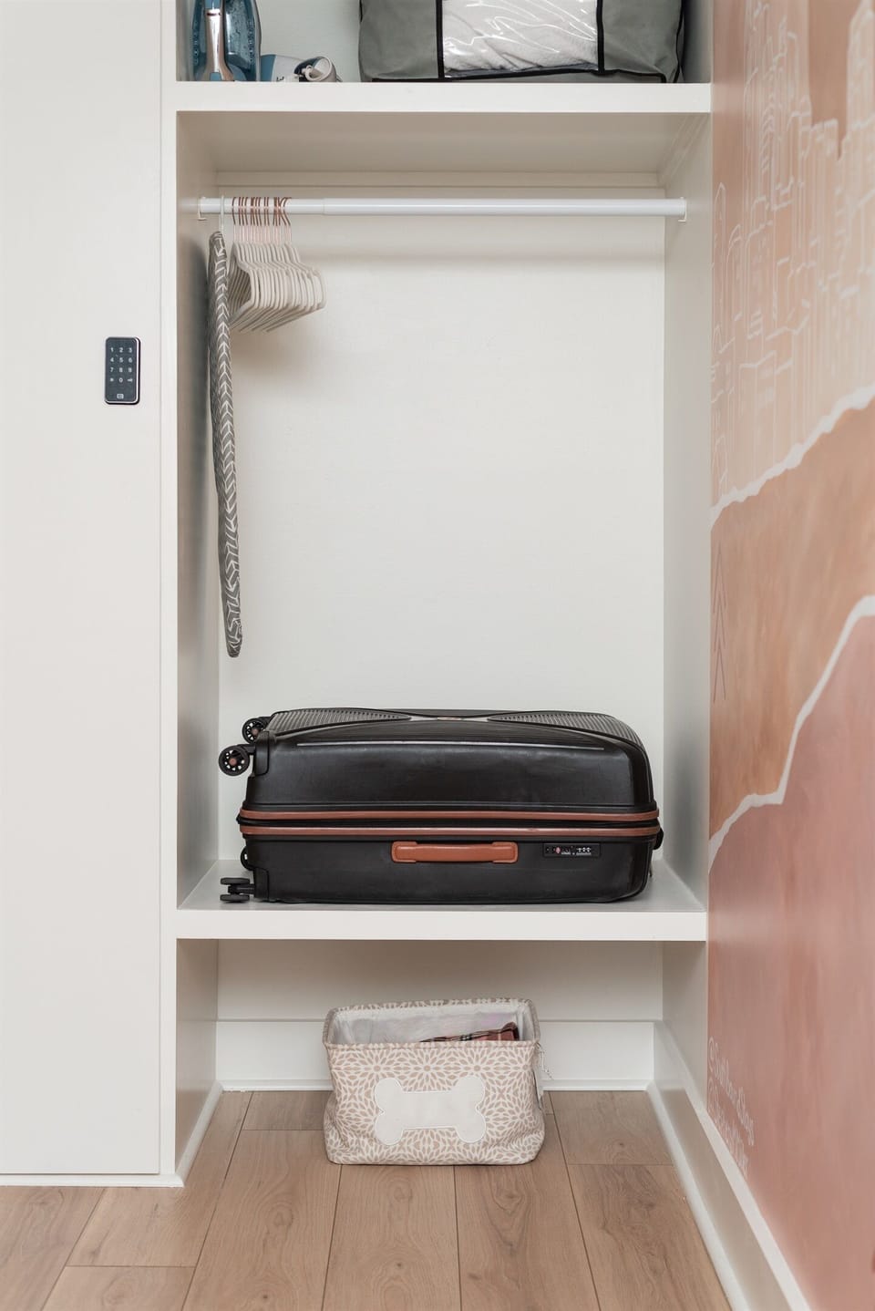 Closet space with built in luggage shelf.