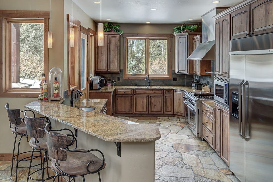 Gourmet kitchen with dacor commercial fridge, viking range, two ovens.