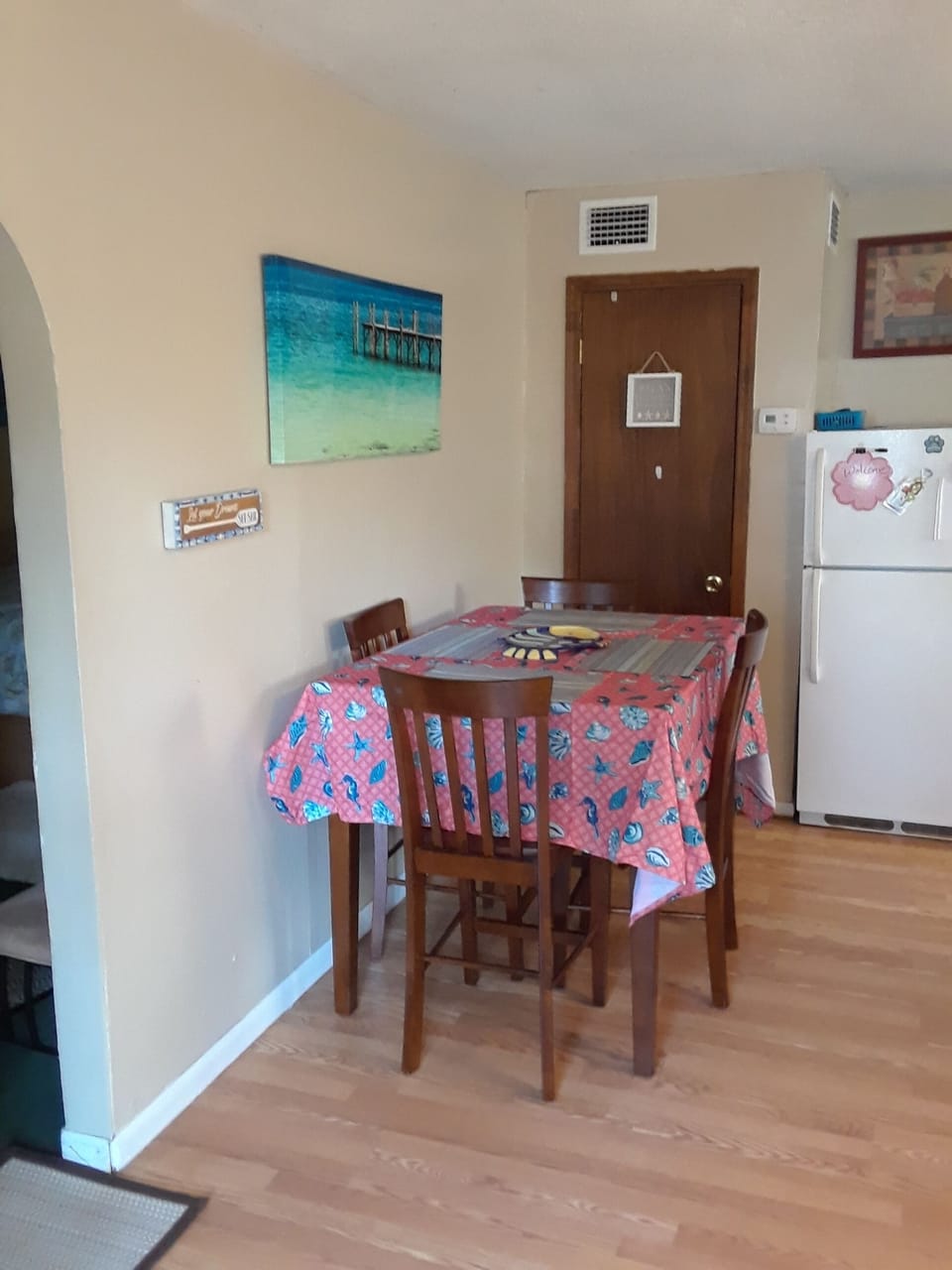 refrigerator, indoor dining table with 4 chairs.