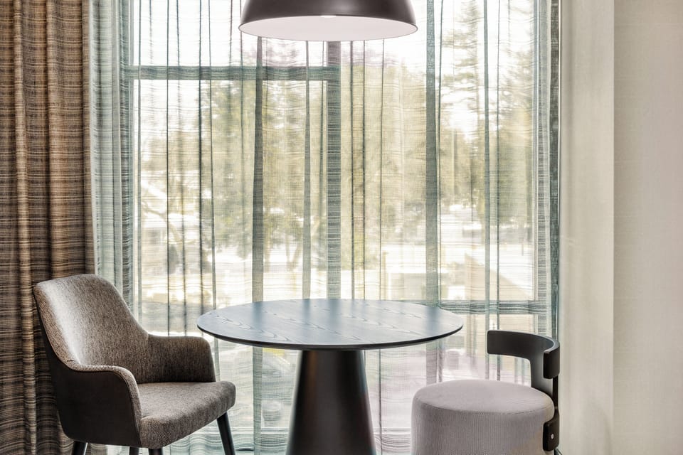 Hypo-allergenic bedding, desk, laptop workspace, blackout drapes