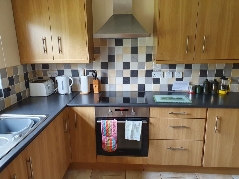 Fully fitted kitchen with oven, hob, dishwasher, fridge and freezer