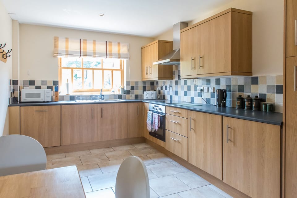 Fully fitted kitchen with oven, hob, dishwasher, fridge and freezer