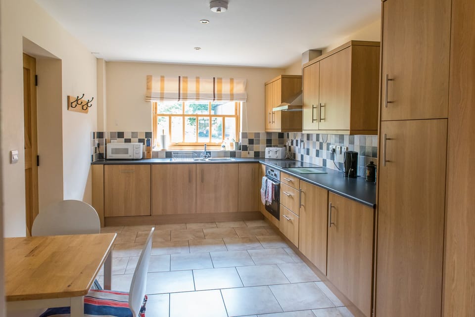 Fully fitted kitchen with oven, hob, dishwasher, fridge and freezer