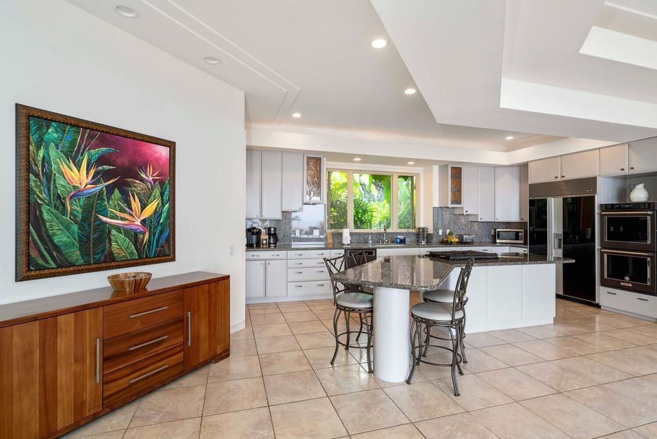 Spacious kitchen with bar seating and generous counter space for gathering.