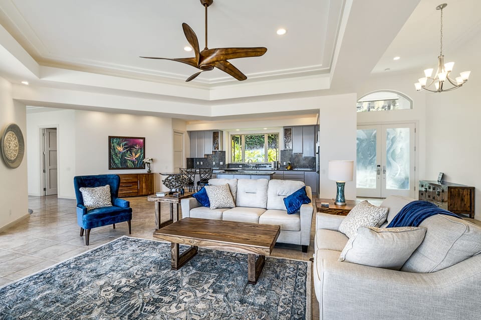 Open living room with vaulted ceilings, ceiling fans, and comfortable seating for gathering.