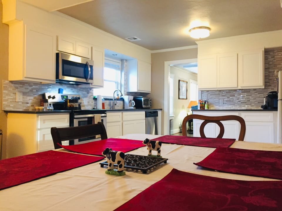 Kitchen with stove, oven, microwave, fridge and all cooking implements, spices 