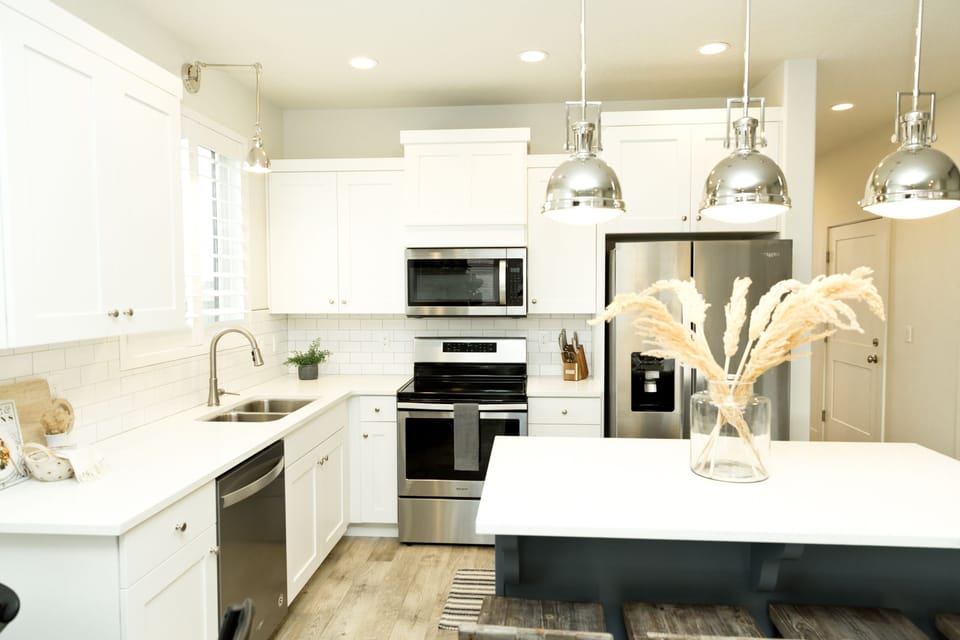 Bright, fully equipped kitchen with bar seating and fun decor.