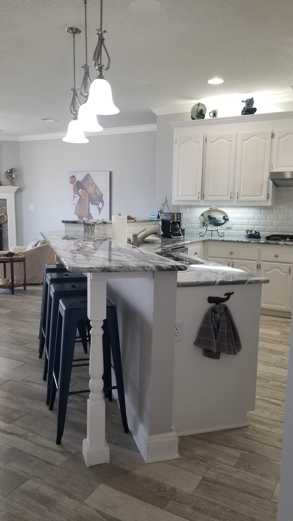 Kitchen has eat at bar and breakfast table. Kitchen also has view of the water.