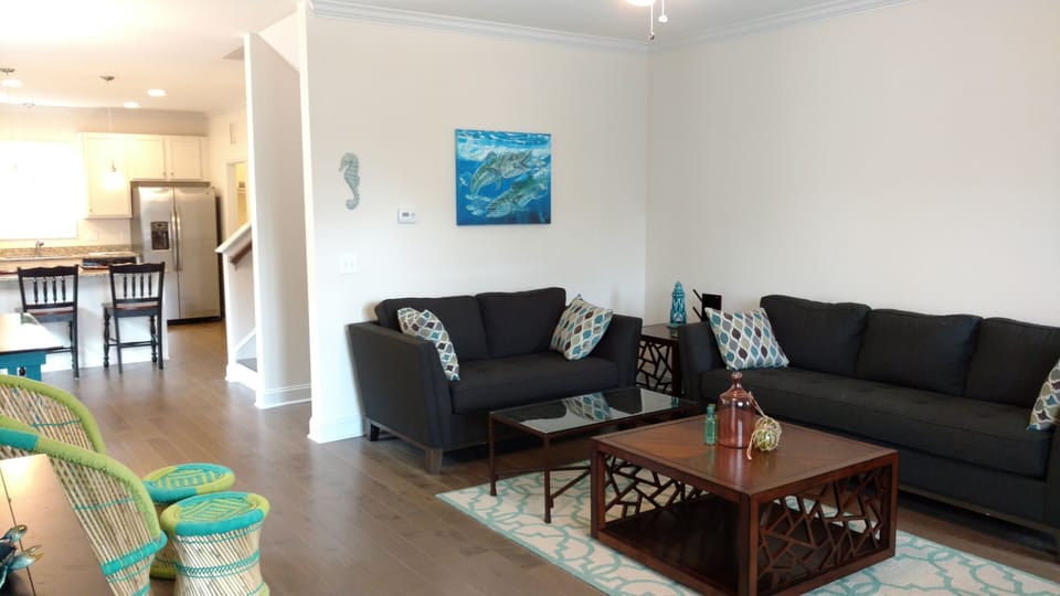 Living room with sofa, love seat. Open to Kitchen and dining area.