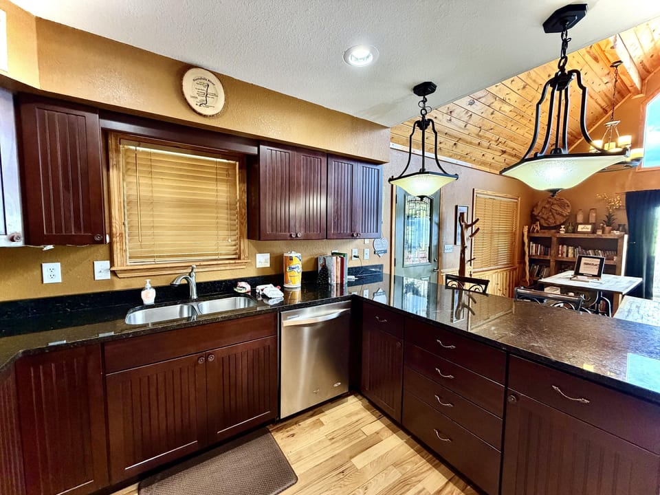 Open concept floor plan, soaring ceilings, and a well appointed chefs kitchen offering everything you need to enjoy preparing your meals at the cabin.