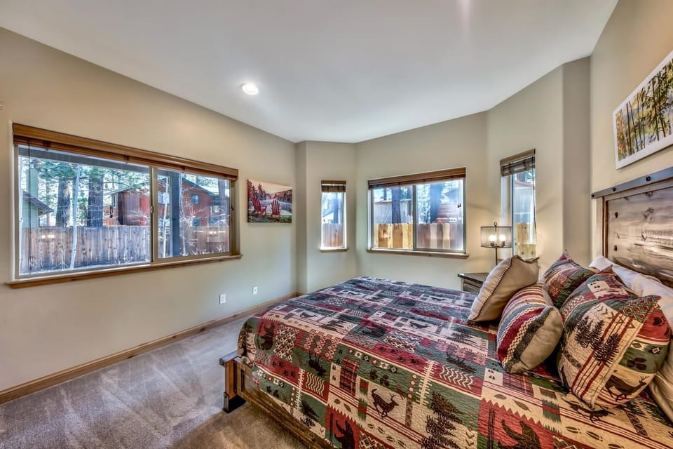 Downstairs bedroom four hosts a queen bed and spectacular windows